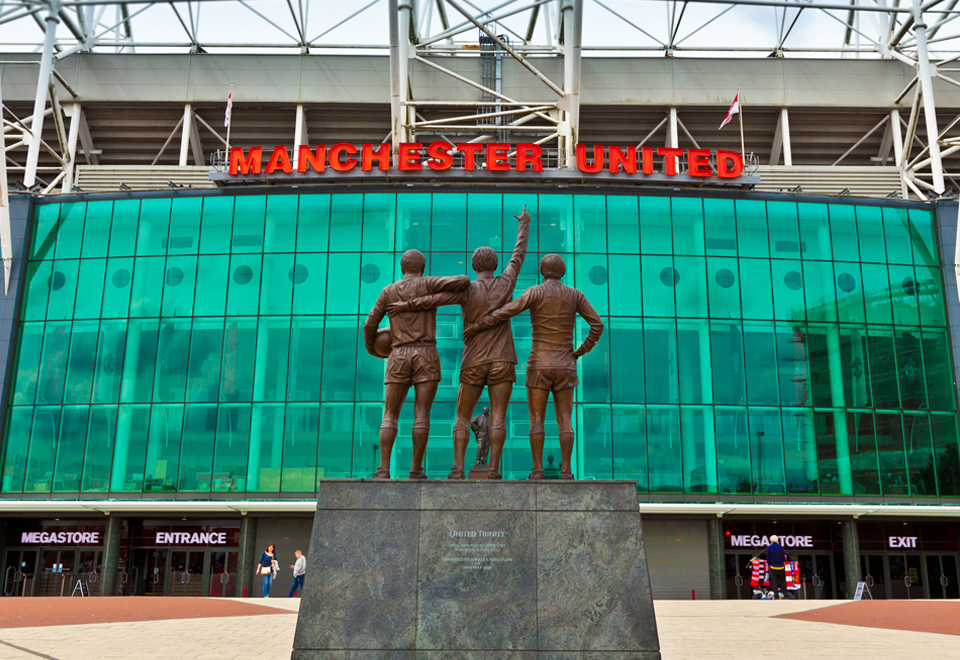 The United Trinity outside Manchester United's stadium. These are the sculptures of the trio of players George Best, Denis Law, and Sir Bobby Charlton, who helped Manchester United become the first English club to win the European Cup in 1968.